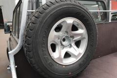 Headboard mounted spare wheel